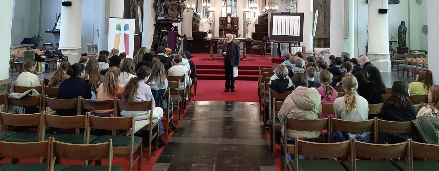 Diaken Jean-Marie vertelt aan de vormelingen hoe een eucharistieviering is opgebouwd © Evelien Van Heyst
