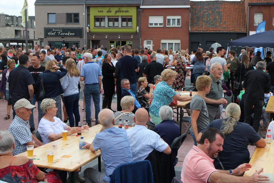 Een dorpsplein vol meevierende mensen © RvH