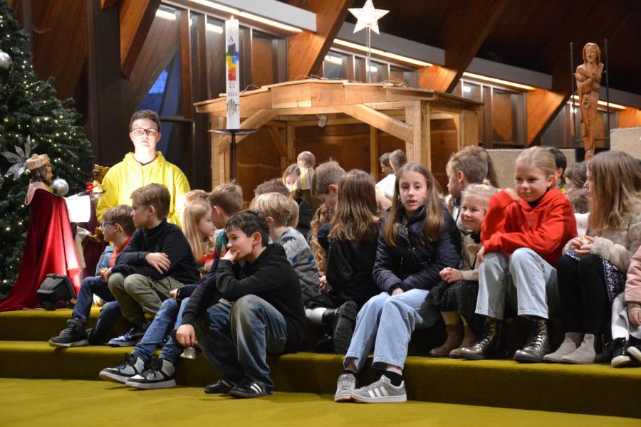 Bij de kerststal luisteren naar het evangelieverhaal © Karen Devroe