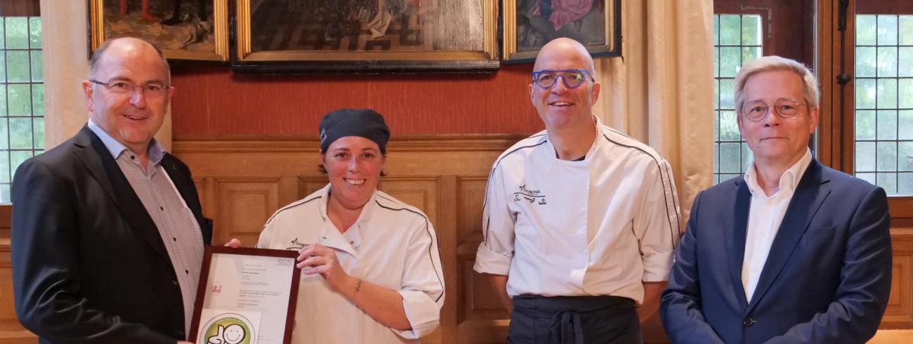 Grootkeuken Grootseminarie behaalt prestigieus smiley-certificaat - vlnr: Antoon Vanhuyse (oud-directeur Grootseminarie Brugge), Sofie Duyck (kok), Wim Missiaen (regioverantwoordelijke Brugge), Johan De Witte-Vroman (huidig directeur Grootseminarie) © Michiel Van Mulders