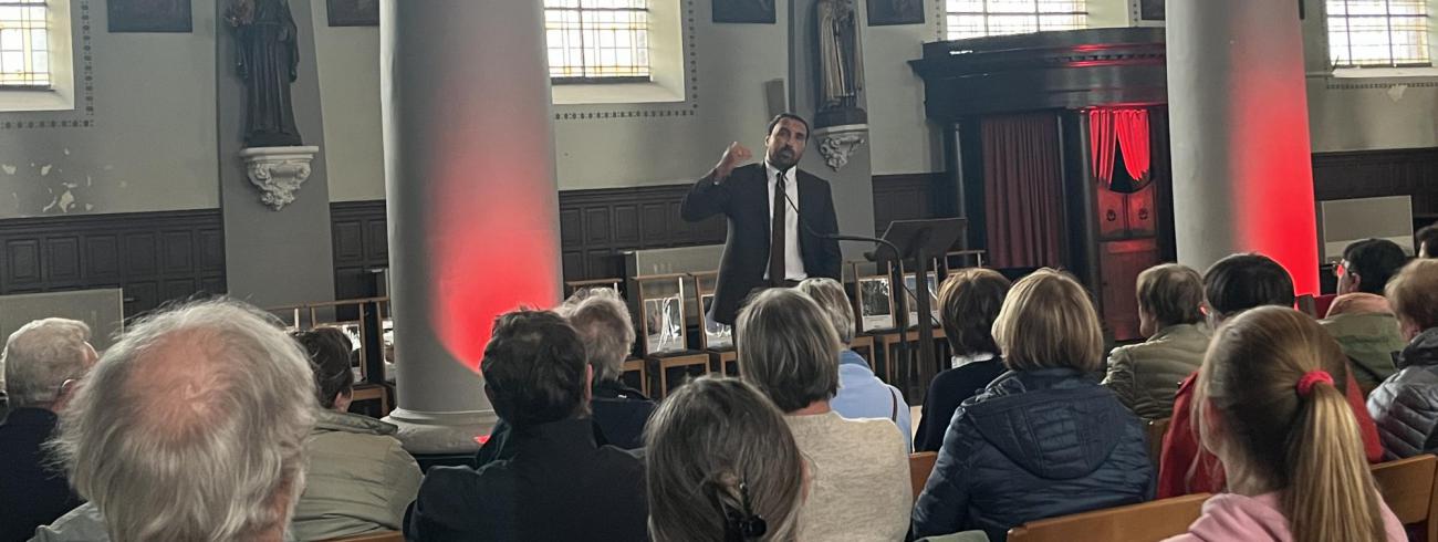 Met de biechtstoel op de achtergrond begon Khalid zijn verhaal. 