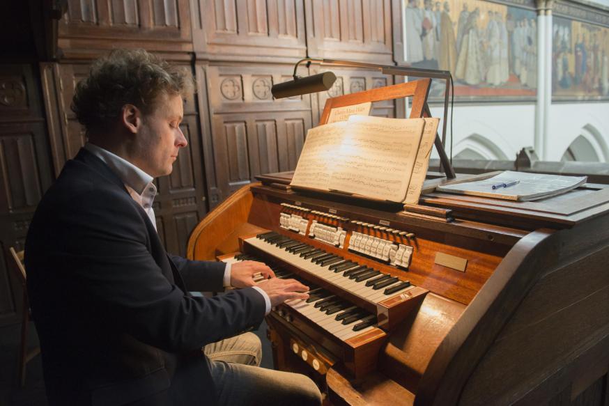 Organist Emmanuel Van Kerckhoven aan de speeltafel van het Loret-orgel in de Antwerpse Sint-Norbertuskerk © Ilse Prinsen