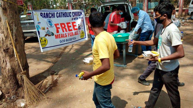 Vrijwilligers van het aartsbisdom Ranchi delen gratis lunchpakketten uit aan familieleden van coronapatiënten aan een van de openbare ziekenhuizen van de stad © VaticanNews