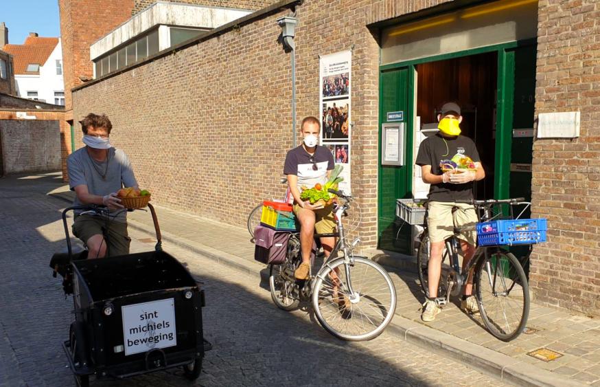 Voedselbedeling door jongeren van de Sint-Michielsbeweging in Brugge. Priester Lode Vandeputte op de fiets. © Sint-Michielsbeweging